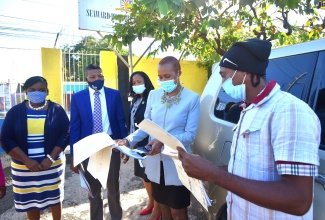 Minister of Education, Youth and Information, Hon. Fayval Williams (second right), looks at the temperature log for students of Seaward Primary & Junior High School  in Kingston during a visit to the institution on Tuesday (January 5). Looking on (from left) are  Principal, Arlene Thomas;  Education Officer, Ricardo Kennedy;  Acting Regional Director, Region 1, Dasmine Kennedy; and Security Guard at the school, Garfield Gordon (right).

 