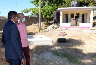 State Minister in the Ministry of Education, Youth and Information, Hon. Robert Morgan (left), in discussion with Chairman of the Board of Crescent Primary School in Spanish Town, St. Catherine, Councillor Norman Scott, while viewing the isolation unit at the school, recently.