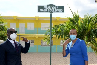  Minister of Education, Youth and Information, Hon. Fayval Williams (right), and Principal of the Marlie Mount Primary and Infant School, in St. Catherine,  Calvin Harris, highlight one of the new signs erected at the new 10-classroom block that was opened on January 14.

 