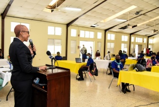 Minister of Education, Youth and Information, Hon. Fayval Williams (at lectern), offers words of encouragement to students participating in the Coding Internship Programme at the Stony Hill HEART/NSTA campus in St. Andrew. Ms. Willliams visited the institution, recently, along with National Coordinator for the Housing, Opportunity, Production and Employment (HOPE) Programme, Lt. Col. Martin Rickman; and Chief Executive Officer (CEO), Amber Group, Dushyant Savadia. Under the Coding Internship Programme, thousands of young Jamaicans will be trained as software developers to create cutting-edge technologies through a one-year residential training programme at the Amber HEART Coding Academy. It is a partnership between the HEART NSTA/Trust and the Amber Group, in collaboration with the HOPE Programme and the Art of Living Foundation.
