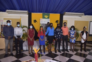 Attorney-at-law and member of the Jamaica Constabulary Force (JCF), Joy Carter (centre), who is a former ward of the State, shares a moment with some wards of the State, who have been recognised by the Child Protection and Family Services Agency (CPFSA), for outstanding achievement in the 2020 Caribbean Secondary Education Certificate (CSEC) and Caribbean Advanced Proficiency (CAPE) examinations. The awards ceremony was held on Friday (January 29) at the Terra Nova All-Suite Hotel in St. Andrew.