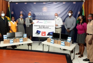 Education, Youth and Information Minister, Hon. Fayval Williams (4th left) with (from left): Principal of the Donald Quarrie High School, Talbert Weir; student Ceandra O’Connor; Acting Chief Education Officer in the Ministry of Education, Youth and Information, Dr. Kassan Troupe; General Manager, Carib Cement Limited, Yago Castro; University of the West Indies (UWI) Mona students, Kyle Service and Shanna-Lee Clarke and Donald Quarrie High student, Gavin Millwood. The occasion was the symbolic handover of vouchers for technology and general school supplies, valued at $5.1 million, that were donated by Carib Cement Company Limited. The ceremony was held at the Ministry’s offices in Kingston on Friday (February 5).  