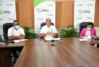 Minister of Health and Wellness, Dr. the Hon. Christopher Tufton (centre), responds to queries from media personnel during the weekly virtual COVID Conversations press briefing on Tuesday (March 23). Flanking Dr. Tufton are Permanent Secretary in the Ministry, Dunstan Bryan; and Chief Medical Officer, Dr. Jacquiline Bisasor-McKenzie.

