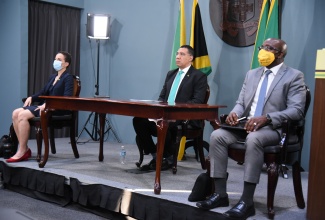 Prime Minister, the Most Hon. Andrew Holness (centre), participates in the opening of a two-day virtual Leaders Summit on Climate, on Thursday (April 22).  Also in attendance (from left) are Minister of Foreign Affairs and Foreign Trade, Senator the Hon. Kamina Johnson Smith; and Minister of Housing, Urban Renewal, Environment and Climate Change, Hon. Pearnel Charles Jr. The Summit was convened by President of the United States, Joseph Biden.

