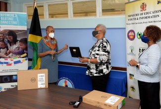 Education, Youth and Information Minister, Hon. Fayval Williams (left) speaks with Chair of the Usain Bolt Foundation, Winsome Wilkins (centre) and Executive Director of the Early Childhood Commission (ECC), Karlene DeGrasse-Deslandes, during the handover of 150 Dell laptop computers at the Ministry’s National Heroes Circle offices in Kingston, on April 16.