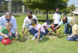 Chargé d'affaires, John McIntyre and Minister of Housing, Urban Renewal, Environment and Climate Change, Hon. Pearnel Charles Jr., along with their families plant two trees at the U.S. Embassy in commemoration of Earth Day, April 22, 2021.

