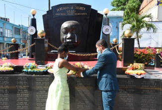 Kingston’s Mayor, Senator Councillor Delroy Williams (right), and Kingston and St. Andrew Municipal Corporation (KSAMC) Youth Councillor Representative for the Springfield Division, Reajean Bennett, lay a wreath at the Secret Gardens Monument in downtown Kingston, during a ceremony on Sunday (May 2) in memory of the nation’s children who have died under violent/tragic circumstances. The ceremony formed part of the Corporation’s activities commemorating Child Month during May under the theme: ‘I Strive to Overcome Adversities with Resilience’ (I.S.O.A.R.).  