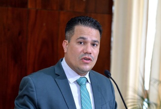 Minister without Portfolio in the Ministry of National Security, Senator the Hon. Matthew Samuda, providing an update on the E-Commerce National Delivery System (ENDS) platform during Wednesday's (May 19) post-Cabinet press briefing at Jamaica House.
