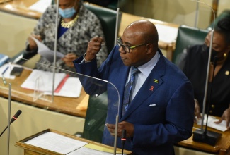 Minister of Tourism and Leader of Government Business in the House of Representatives, Hon. Edmund Bartlett,  closing the 2021/22 Sectoral Debate in the Lower House, on Tuesday (June 15). Also pictured in the background (from left) are Minister of Education, Youth and Information, Hon. Fayval Williams; and Minister of Culture, Gender, Entertainment and Sport, Hon. Olivia Grange.

