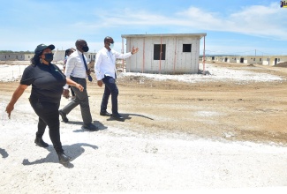 Minister of Housing, Urban, Renewal, Environment and Climate Change, Hon. Pearnel Charles (centre), in conversation with Managing Director of the Housing Agency of Jamaica (HAJ), Gary Howell (right), during the opening of model houses in the Catherine Estates Housing Development in St. Catherine, on Friday (June 25). Accompanying them is Councillor for the Horizon Park Division in the parish, Jennifer Hull.