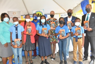 Education, Youth and Information Minister, Hon. Fayval Williams (fifth right), is joined by staff and education stakeholders at Ferris Primary School in Westmoreland, on Thursday, June 17, when 21 tablets valued at $260,000 were handed over to the institution by several non-profit organisations.