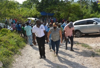 Minister of Housing, Urban Renewal, Environment and Climate Change, Hon. Pearnel Charles Jr. (left), and Member of Parliament for St. Ann North Western, Krystal Lee (right), tour  Mt. Edgecombe, in St. Ann, on Friday, June 18.