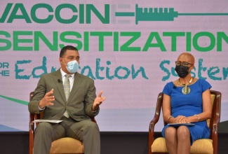 Prime Minister, the Most Hon. Andrew Holness (left),  fields questions from the public during a virtual Town Hall on Vaccine Sensitisation for the Education System on Friday (June 11). Also pictured is Minister of Education, Youth and Information, Hon. Fayval Williams.