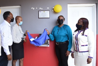 Minister of Education, Youth and Information, Hon. Fayval Williams (second left) and Wife of the Prime Minister and Member of Parliament for East Rural St. Andrew, the Most Hon. Juliet Holness (second right) unveil a plaque at the official opening of new bathroom facilities at Hall’s Delight Primary School on June 10. Sharing in the moment are Managing Director, JSIF, Omar Sweeney (left) and Principal, Hall's Delight Primary School, Denise Dunchie.

 