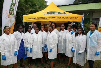 Coordinator of the Scientific Research Council (SRC) Science and Technology Education Unit, Kavelle Hylton (right), shares a photo opportunity with students during a science fair held in 2019.  (Photo: Contributed)
