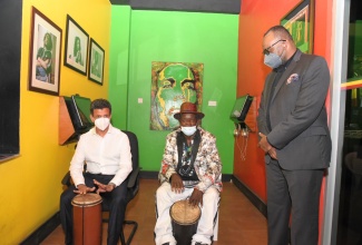 Minister of Tourism for Saudi Arabia, His Excellency Ahmed Al Khateeb (left), plays the drum with Percussionist, Bongo Herman, during a tour of the Bob Marley Museum in St. Andrew on Wednesday (June 23). Looking on is Director of Tourism at the Jamaica Tourist Board, Donovan White.

