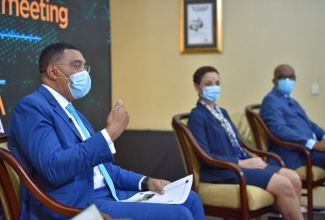 Prime Minister, the Most Hon. Andrew Holness (left), responds to queries during a Prime Ministerial town hall meeting, held as part of a virtual Jamaica Diaspora Sustainability Symposium on Wednesday (June 16).  Also pictured (from second left) are Minister of Foreign Affairs and Foreign Trade, Senator the Hon. Kamina Johnson Smith; and State Minister in the Ministry of Foreign Affairs and Foreign Trade, Senator the Hon. Leslie Campbell.

