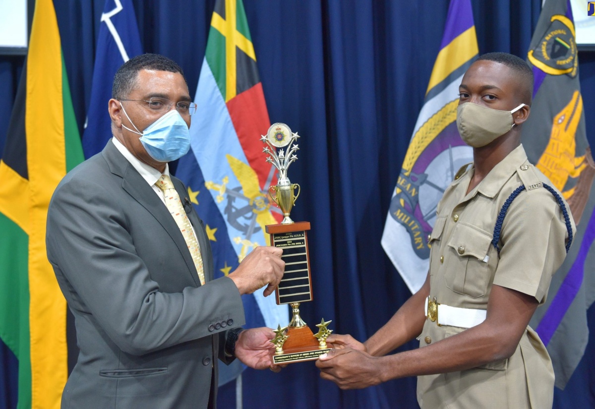 Prime Minister, the Most Hon. Andrew Holness (left), presents Private (NS) Orrington Harvey with the runner-up trophy for the Jamaica Defence Force (JDF) Commandant's award. Private Harvey is one of two outstanding recruits of the Jamaica National Service Corps (JNSC) specially recognised during the Certification Ceremony for the ninth batch of recruits at Up Park Camp in Kingston on Friday (June 4).

 