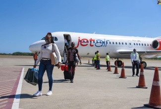 Passengers arrive on the inaugural Jet Air Caribbean flight from Curaçao International Airport to Norman Manley International Airport in Kingston, on Thursday, July 1.