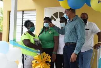 Prime Minister, the Most Hon. Andrew Holness (second right), displays keys for the new three-bedroom house handed over to Dawnette Henry (left), at a  social housing ceremony, held on July 16, in Farm Pen, St. Mary. Sharing the moment (from second left) are: Councillor for the Carron Hall Division, Doreen Hutchinson; Member of Parliament for Western St. Mary, Hon. Robert Montague, and Mayor of Port Maria, Councillor Richard Creary.