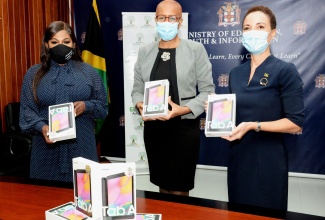 Minister of Education, Youth and Information, Hon. Fayval Williams (centre), Jamaica’s Consul General to New York, Alsion Roach Wilson (left); and Minister of Foreign Affairs and Foreign Trade, Senator the Hon. Kamina Johnson Smith (right), display tablets during a handover ceremony at the Education Ministry's National Heroes Circle location in Kingston on Wednesday (July 21). Over 1,400 tablets and laptops were donated by the Consul General, for distribution to needy students across the island. 