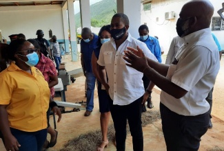 Minister of Agriculture and Fisheries, Hon. Floyd Green (centre), interacting with Livestock Research Officer, Karayan Holt (left), and Chief Livestock Research Officer in the Ministry of Agriculture and Fisheries, Audley Facey, at the launch of the National Small Ruminant Development Programme at Hounslow Research Station in St. Elizabeth recently.