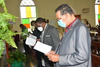 Minister of State in the Ministry of Local Government and Rural Development, Hon. Homer Davis (right); Mayor of Montego Bay, Councillor Leeroy Williams (2nd right); and Custos Rotulorum for St. James, Bishop the Hon. Conrad Pitkin (2nd left), join other congregants in singing a hymn during an Independence Church Service at Maldon Baptist Church in St. James on Sunday (August 1). 