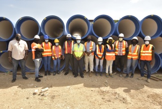 National Water Commission (NWC) Vice President, Garth Jackson (fifth left), along with Project Coordinator at M&M Jamaica Limited, Michael Hemming (sixth left), and Deputy Managing Director at M&M Jamaica Limited, Richard Mullings (sixth right), with other workers on the Spanish Town leg of the major NWC improvement project recently.

