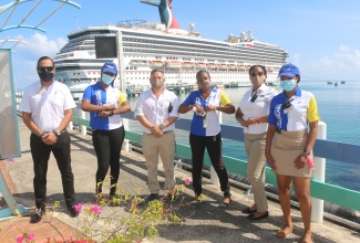 Tour operators and attraction owners were out in full force yesterday to greet the arrival of the Carnival Sunrise. Here we see Regional Manager for Dolphin Cove Gonzalo Pacheco (first left) and Manager for Cruise Ship Operations for Dolphin Cove, Enrique Rivera (third left), and other members of their team at the Ocho Rios Cruise Ship Port, St. Ann, on Monday (August 16).  The occasion was the arrival of the first cruise ship in Jamaica following a 17-month absence. 