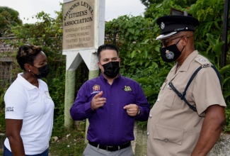 Minister without Portfolio in the Ministry of National Security, Senator the Hon. Matthew Samuda (centre), in discussion with Minister of State in the Ministry of Health & Wellness and Member of Parliament for West Rural St. Andrew, Hon. Juliet Cuthbert Flynn (left), and Superintendent of Police Aaron Fletcher during a recent tour of the Stony Hill and Red Hills communities in the constituency.

