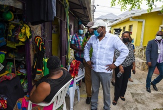 Minister of Tourism, Hon. Edmund Bartlett, interacts with craft traders at the Olde Fort Market in Ocho Rios, St. Ann, on a visit to the facility on August 13.

