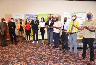 Minister of Health and Wellness, Dr. the Hon. Christopher Tufton (fifth left), shares a moment with representatives of private entities that will be administering the coronavirus (COVID-19) vaccines to Jamaicans at sites across the island, during the signing ceremony held on Monday (September 27), at The Jamaica Pegasus hotel in New Kingston.

