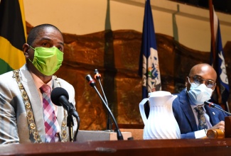 Mayor of Kingston, Senator Councillor Delroy Williams (left), addresses the Kingston and St. Andrew Municipal Corporation (KSAMC) monthly meeting held on Wednesday (September 22) at the Jamaica Conference Centre, downtown Kingston. Also pictured is Chief Executive Officer of the KSAMC, Robert Hill.

