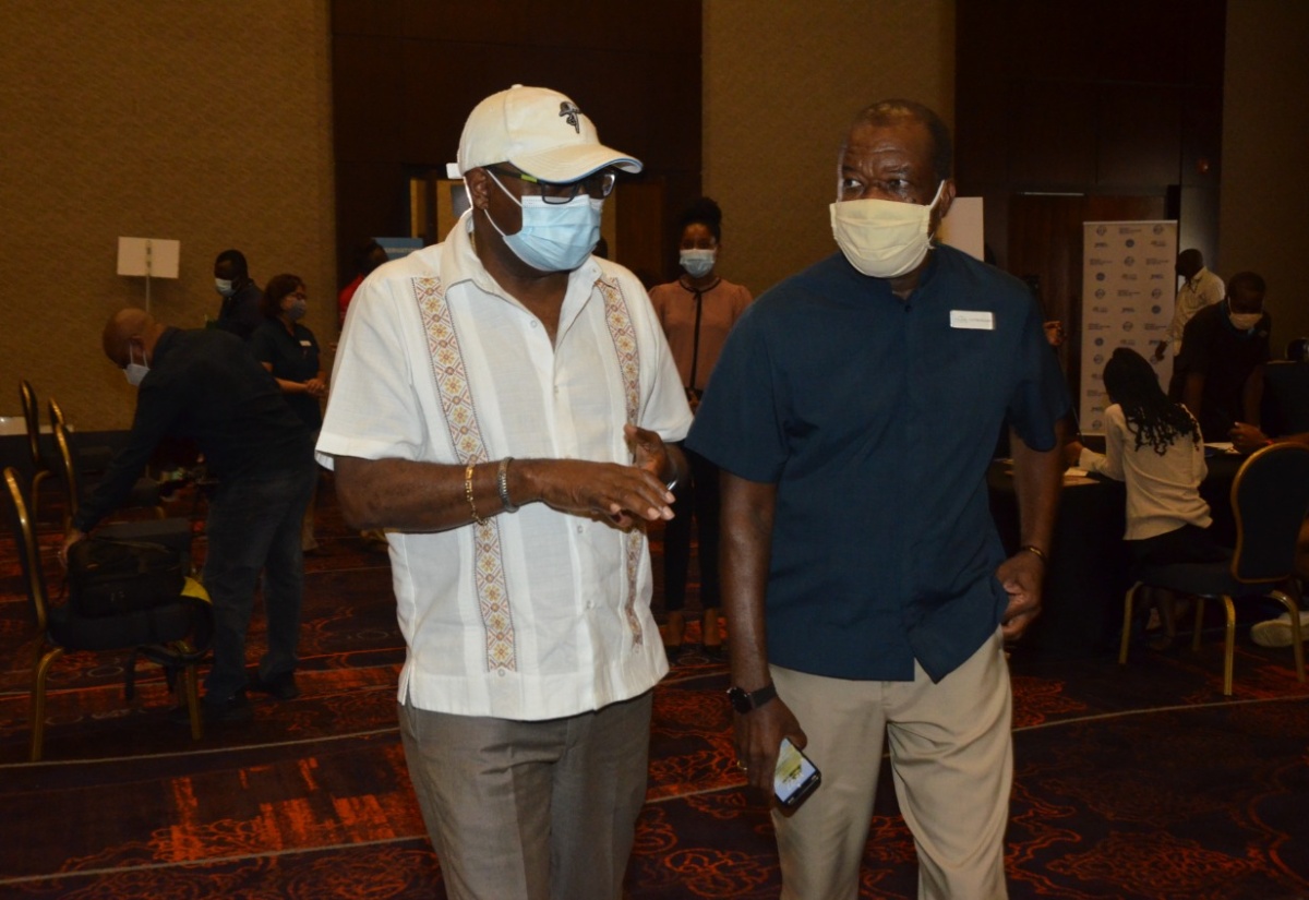 Minister of Tourism, Hon. Edmund Bartlett (left) and President of the Jamaica Hotel and Tourist Association (JHTA), Clifton Reader, are in conversation at the Tourism Vaccination Task Force’s COVID-19 vaccination blitz held at Moon Palace in Ocho Rios, St. Ann, on Friday, September 3.

 