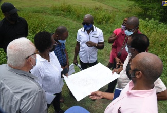 Minister of Housing, Urban Renewal, Environment and Climate Change, Hon.  Pearnel Charles Jr. (centre), makes a point while on a tour of 21 Juno Crescent May Pen, Clarendon, on September 16. Listening (from left) are: Member of Parliament for Central Clarendon, where the community is located Mike Henry; the Ministry’s Chief Technical Director, Doreen Prendergast, and Technical Officer, Shane Myers; Councillor for the May Pen East Division, Kenneth Davis;  Councillor for the Denbigh Division, Joel Williams; and Acting Senior Director in the Ministry, Clinton Clemmings.