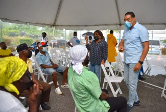 Prime Minister, the Most Hon. Andrew Holness (right), addresses residents who received their coronavirus (COVID-19) vaccine at a vaccination blitz at Troy High School in Southern Trelawny on Thursday (September 23). He was joined by Member of Parliament for Southern Trelawny, Marisa Dalrymple-Philibert (left). 