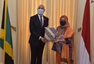 Governor-General, His Excellency the Most Hon. Sir Patrick Allen (left), displays Letters of Credence from the Ambassador-designate of the Republic of Indonesia, Dr. Nana Yuliana, during a  call at King’s House on October 28.