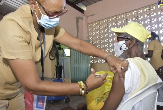 Public Health Nurse attached to the Kingston and St. Andrew Health Department, Fern Henlon, vaccinates resident of Pembroke Hall, St. Andrew, Donald Deavers, during the community’s recent coronavirus (COVID-19) vaccination blitz, organised by the Ministry of Health and Wellness.   
