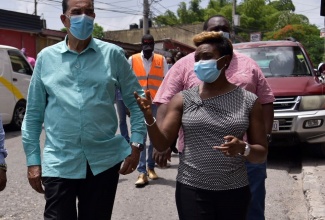 State Minister, Ministry of Local Government and Rural Development, Hon. Homer Davis, converses with Minister of State for Health and Wellness and Member of Parliament, St. Andrew West Rural, Juliet Cuthbert- Flynn, during a tour of the Lawrence Tavern Division, recently. Lawrence Tavern is one of five communities selected for upgrading under the $650-Million Rural Development Programme. 