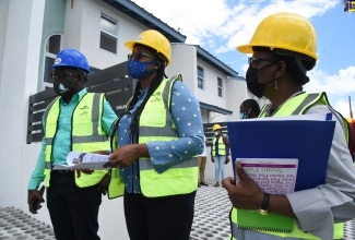 Minister of Housing, Urban Renewal, Environment and Climate Change (MHURECC) Hon. Pearnel Charles Jr (left) views the Harbour Head Seascape Development with Member of Parliament for East Rural St. Andrew, the Most Hon. Juliet Holness (center) and Chief Technical Director in MHURECC, Mrs. Doreen Prendergast on October 1. 