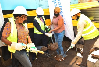 Minister of Local Government and Rural Development, Hon. Desmond McKenzie (second left), and beneficiary of the Ministry of Local Government and Rural Development’s Municipal Social Assistance Programme (MSAP), Tashana Mallett (third left), break ground for her housing solution at Ashley Road, St. Andrew, South West, on October 20. Also participating in the exercise (from left) are Member of Parliament, St. Andrew South West, Dr. Angela Brown Burke  and Councillor, Whitfield Town Division, Eugene Kelly.