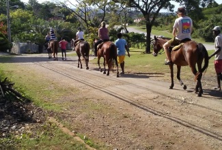 Tour guides taking guests out on a horseback riding tour in Mammee Bay, St. Ann