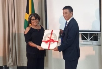 Speaker of the House of the Representatives, Marisa Dalrymple-Philibert (left), accepts a gift from the High Commissioner of India to Jamaica, His Excellency Rungsung Masakui, following her presentation at a Constitution Day reception held on Friday (November 26), at the High Commission of India, St. Andrew, to commemorate India Constitution Day.

