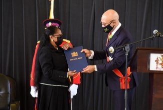 Governor-General His Excellency the Most Hon. Sir Patrick Allen (right), presents newly installed Custos of St. Catherine Hon. Icylin M. Golding with the Grand Commission, at an installation ceremony held today, Tuesday (November 23), at the National Police College of Jamaica, in Twickenham Park, in the parish.