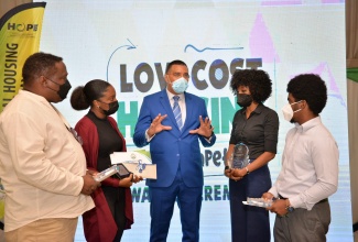 Prime Minister the Most Hon. Andrew Holness (centre) engaged on conversation with winners in the Low - Cost Housing Design competition virtual award ceremony held on Tuesday (November 23). Others pictured from left are: Fitzroy McIntosh; Roni-Kaye McLaren and Suzette Adams–Rickards representing Matandara Clarke Architects; and Zane Finnikin.