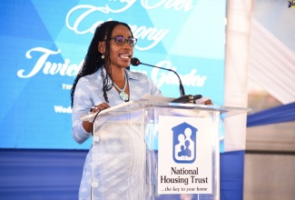 National Housing Trust (NHT) Board member, Nesta-Claire Hunter, speaking during Wednesday’s (December 1) handover ceremony for the Twickenham Glades housing development in St. Catherine.
