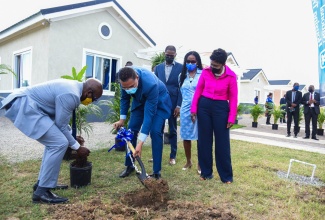 Prime Minister, the Most Hon. Andrew Holness (second left), and Minister of Housing, Urban Renewal and Climate Change, Hon. Pearnel Charles Jr., plant trees at the newly opened Twickenham Glades housing development in St. Catherine, during a handover ceremony on Wednesday (December 1). Looking on are Twickenham Glades homeowner Dwight Bailey (centre); Board member of the National Housing Trust (NHT), which undertook the development, Nesta-Claire Hunter (second right), who represented Board Chairman, Lennox Channer; and Member of Parliament for St. Catherine Eastern, where the development is located, Denise Daley.

