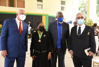 Newly installed Custos of St. Catherine, Hon. Icylin M. Golding (second left) with (from left) Minister of Justice, Hon. Delroy Chuck; immediate former Custos of the parish,  Reverend Jeffrey McKenzie, and Custos of Clarendon, Hon. William Shagoury, after her recent installation, held at the National Police College of Jamaica in Twickenham Park in the parish.