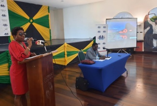 President of the Montego Bay Chamber of Commerce and Industry, Janet Silvera, speaking at the St. James Municipal Corporation’s Multi-Sectorial Forum held recently at the Montego Bay Cultural Centre. Seated is Mayor of Montego Bay, Councillor Leeroy Williams.

