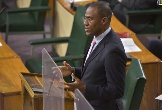 Minister of Finance and the Public Service Dr. the Hon. Nigel Clarke, discusses a matter of importance while making his contribution to the debate on the Second Supplementary Estimates for the 2021/22 fiscal year, during a special sitting of the House of Representatives on Thursday (Jan. 13). 